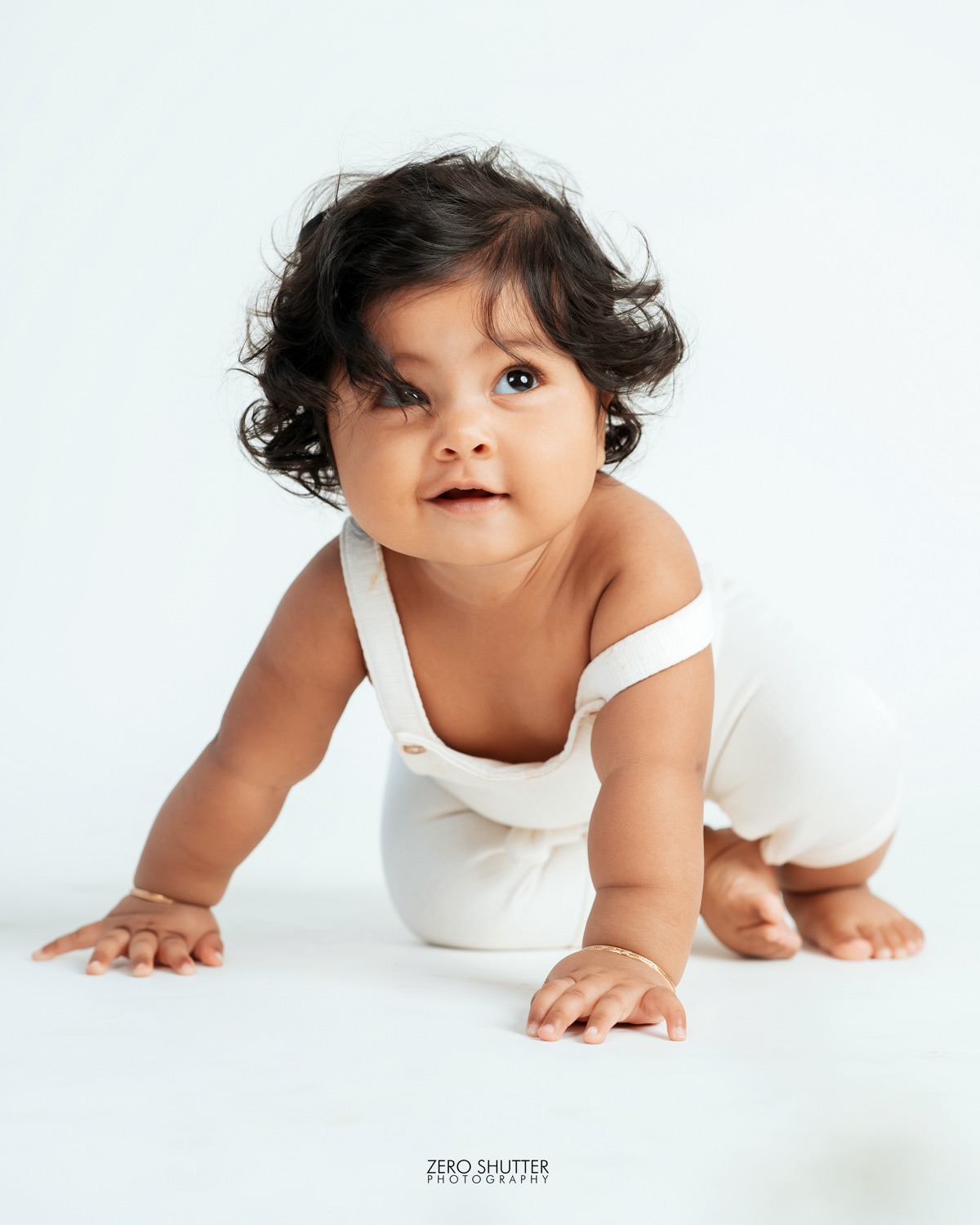 Baby crawling during a bright studio session