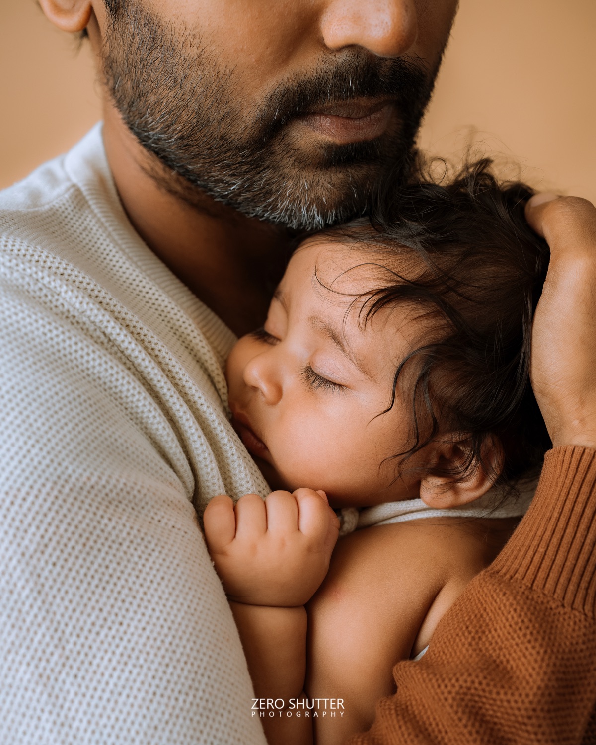 Father holding his sleeping baby against his chest