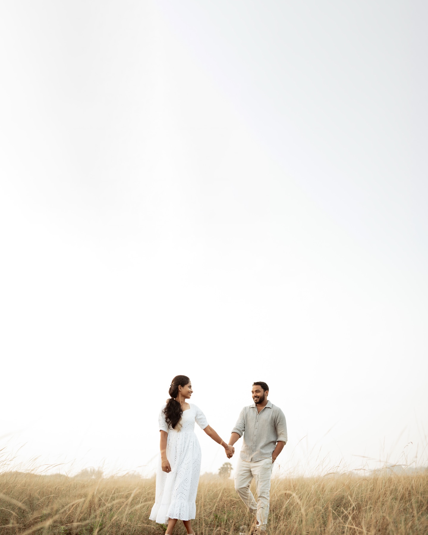 Couple walking together through a misty field