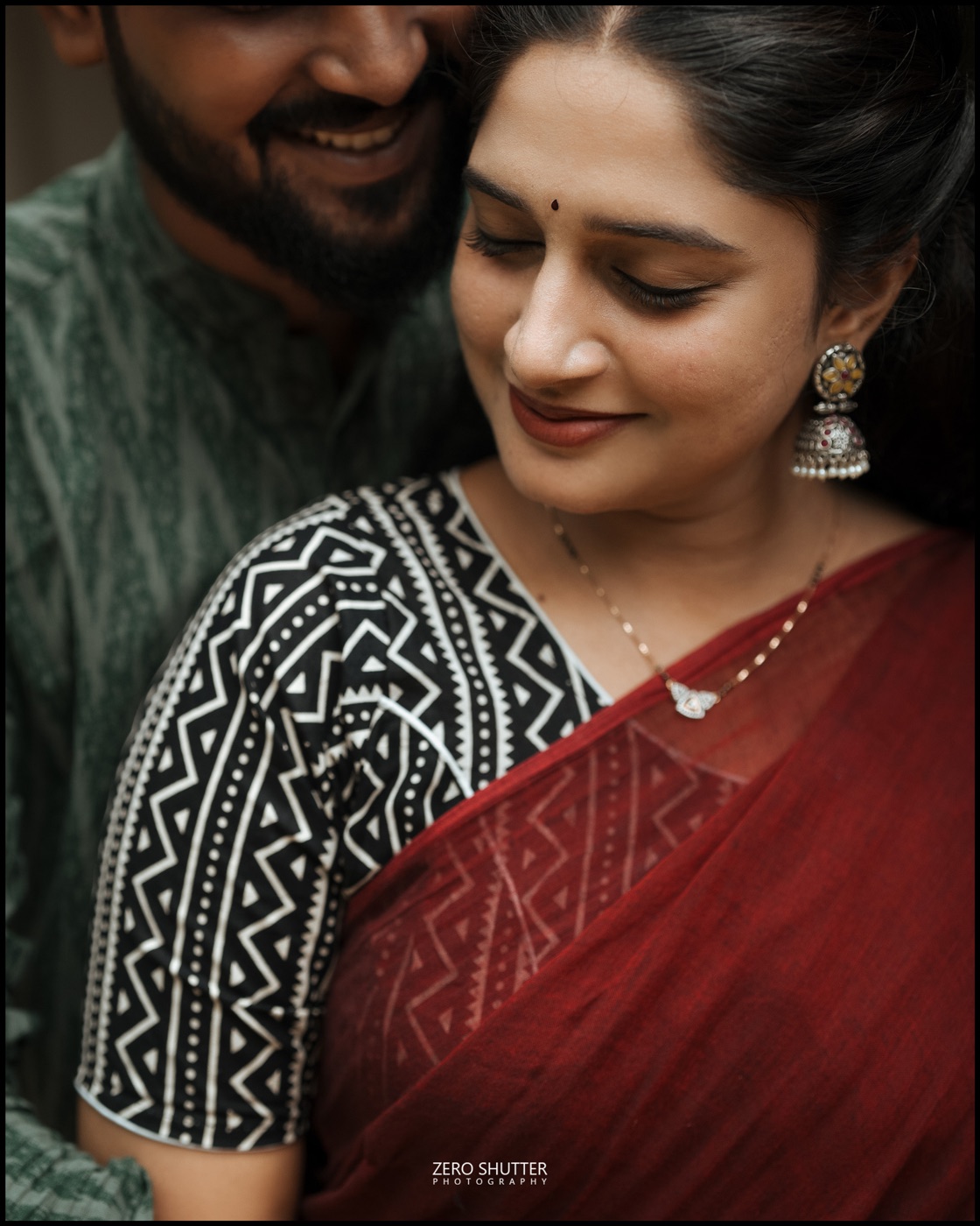 Close portrait of a bride's smile as her husband leans in behind her