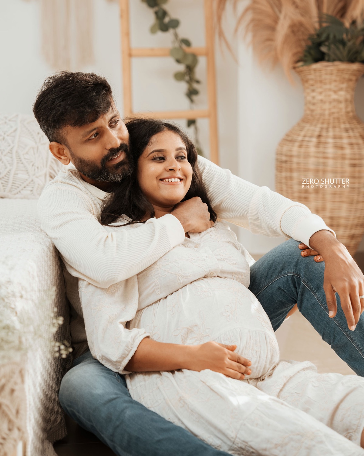 Husband holding his wife close on a studio sofa