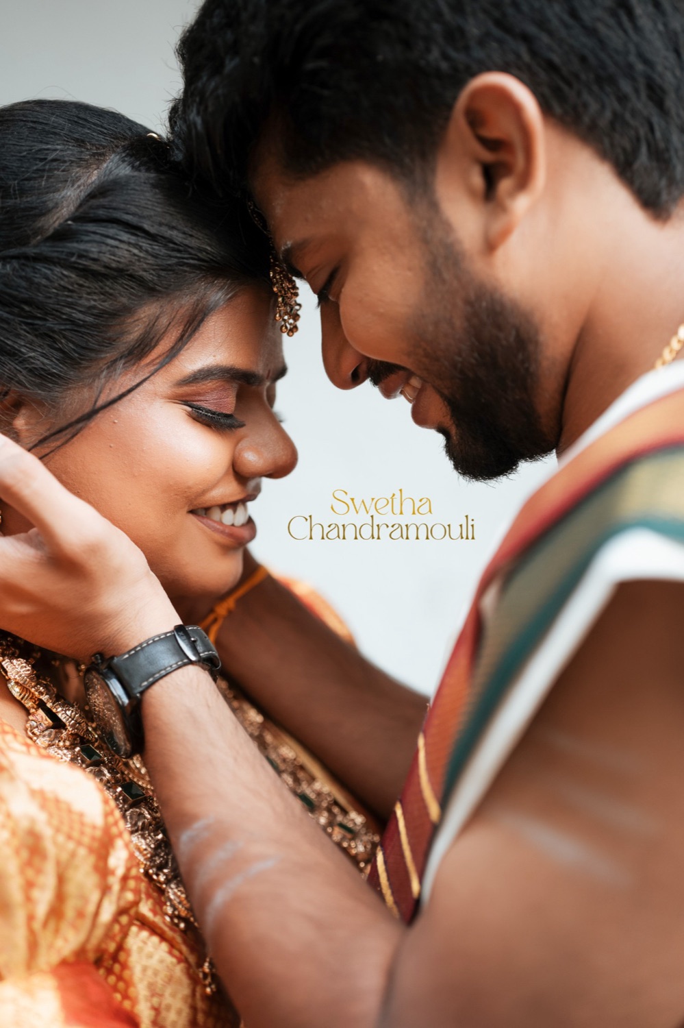 Groom resting his forehead against his bride's, both smiling